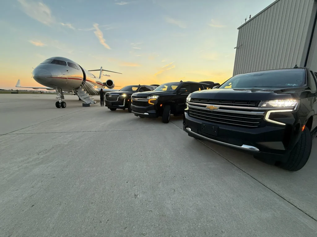 Private jet on the ramp at Teterboro with a black chauffeured SUV waiting